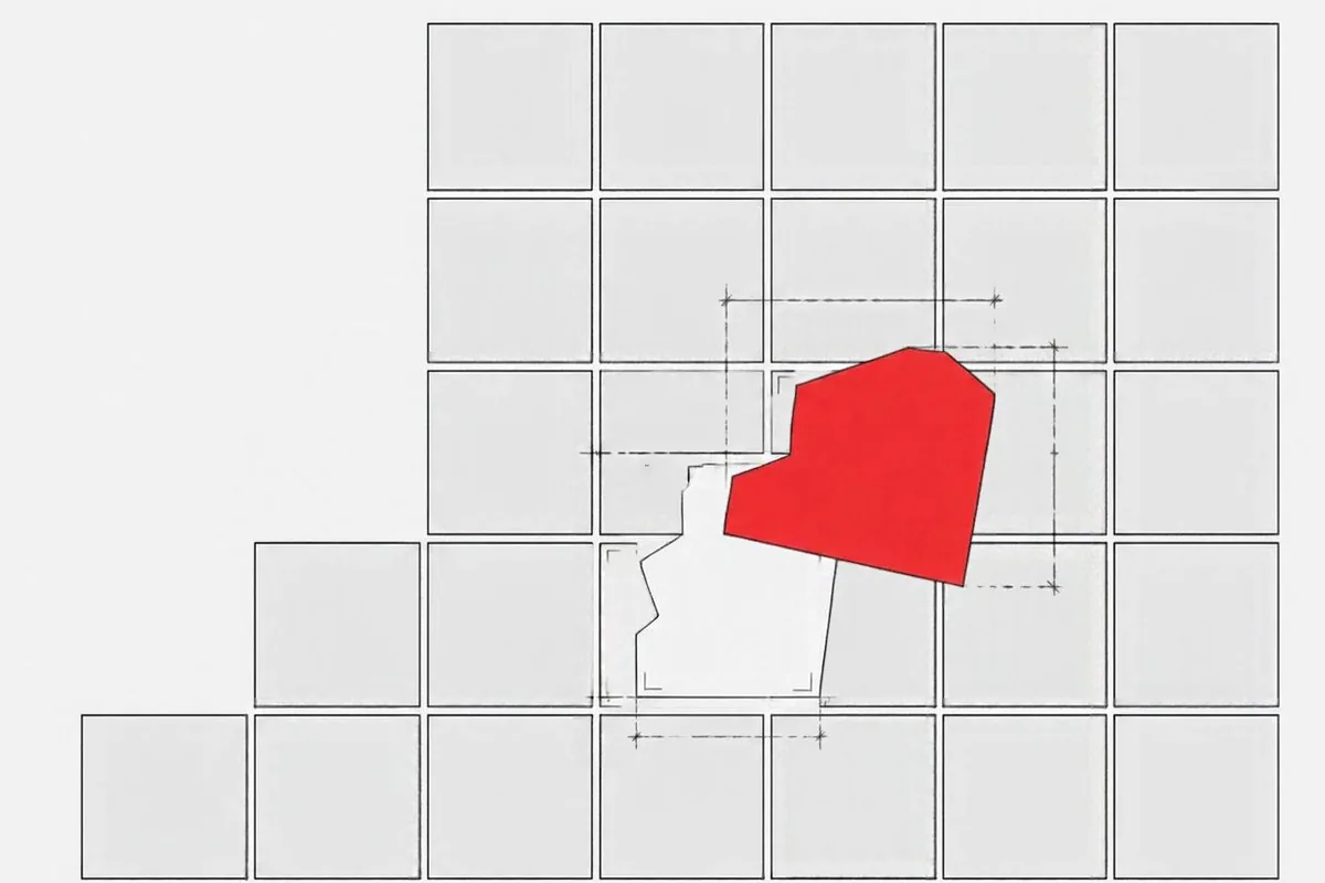 A custom-shaped red tile fitting into a gap in a grid of standard tiles